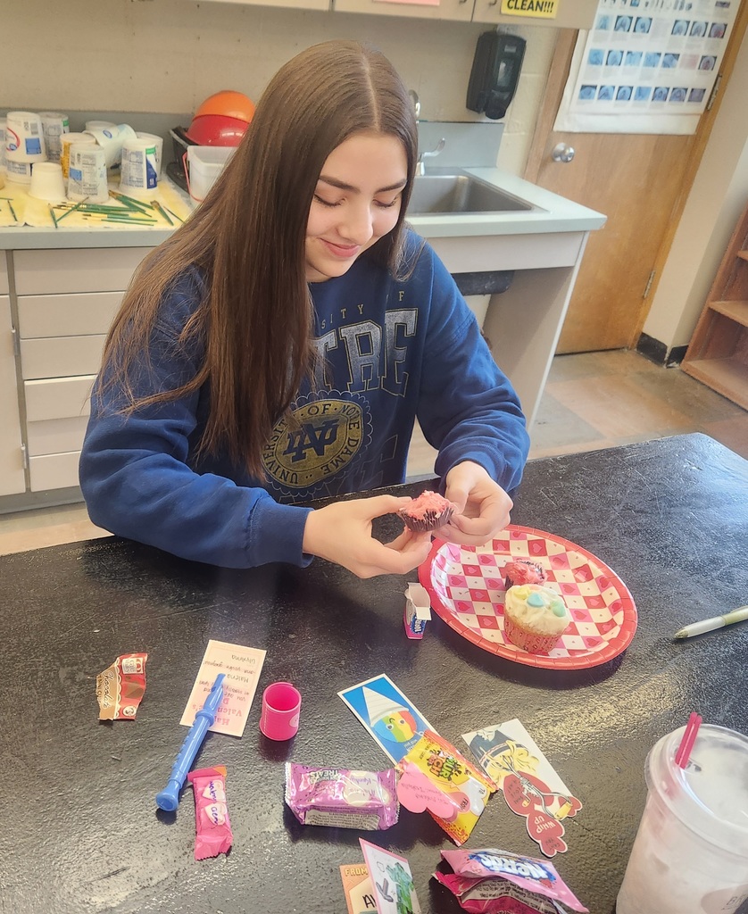 student with treats and valentine's day cards