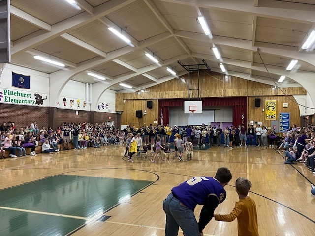 students playing musical chairs at hoco assembly