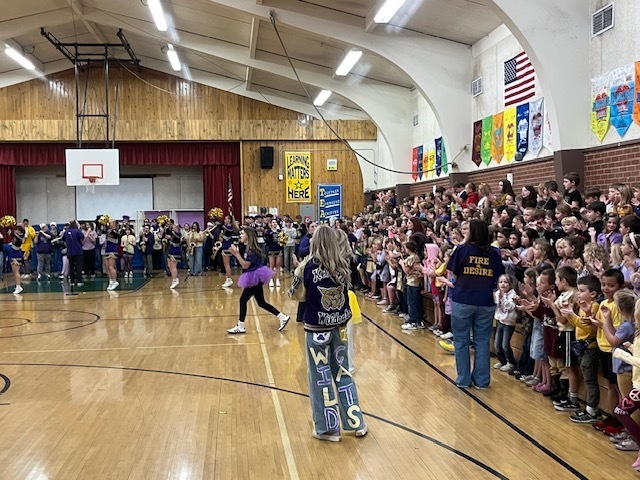 students cheering on elementary students