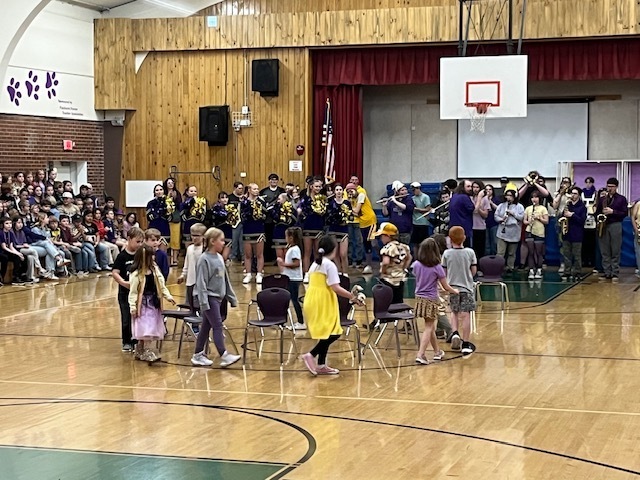 students at assembly- musical chairs