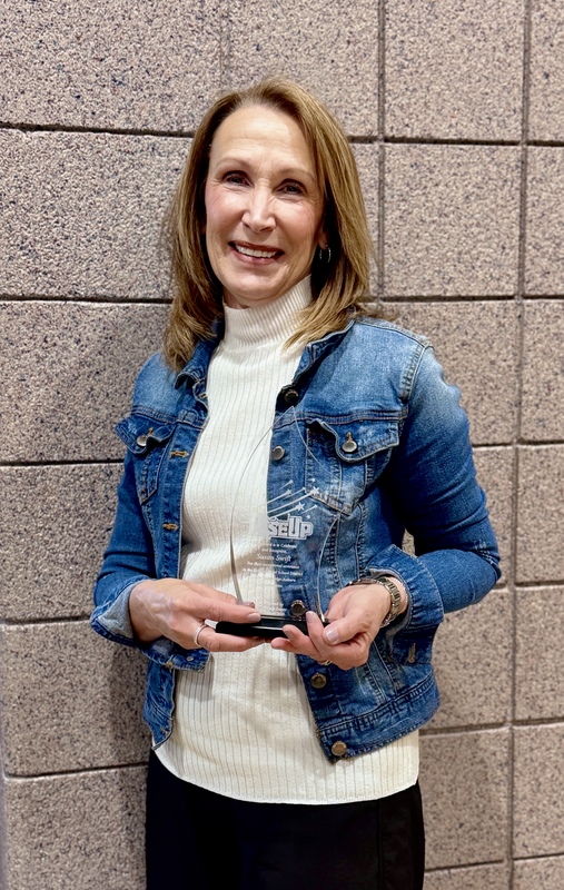 Susan Swift with Rise Up Award Trophy