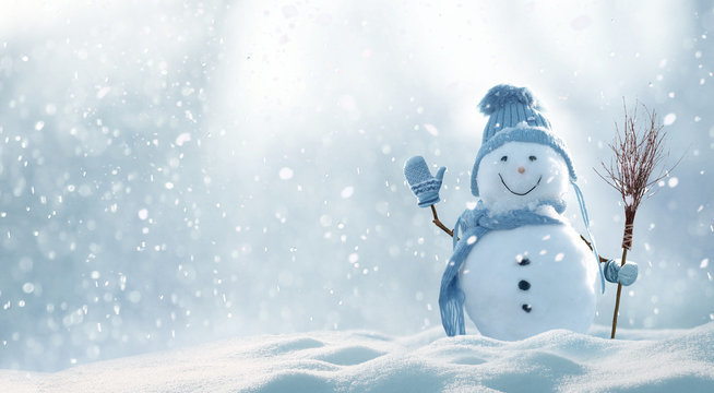 Picture of outside snow falling, snowman with blue hat mittens and scarf