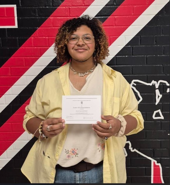 Photo of student holding National Merit Certificate