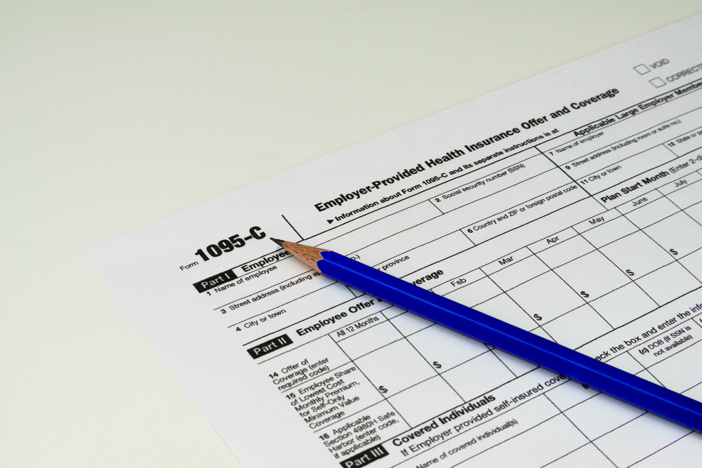 1095-C tax form with pencil on top