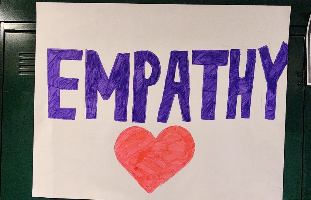 A hand made poster with the word "Empathy" on it and a heart drawn below
