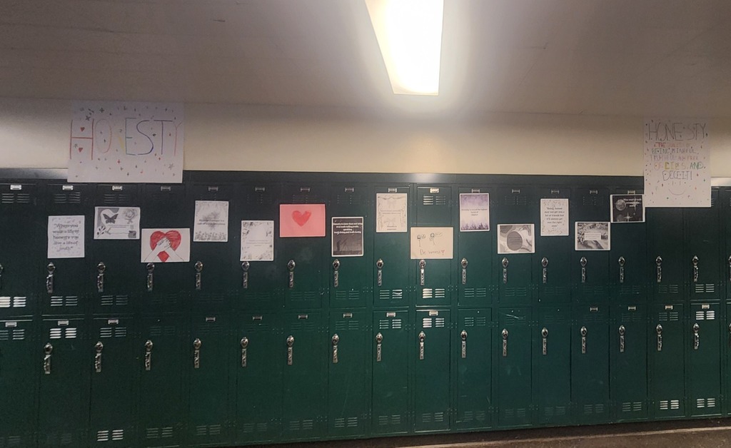 Handmade posters about Honesty across a row of lockers