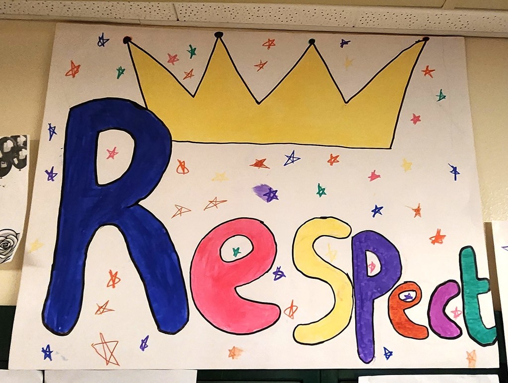 A hand made poster with the word "Respect" on it with a drawing of a crown above the word and colorful stars throughout the whole poster.