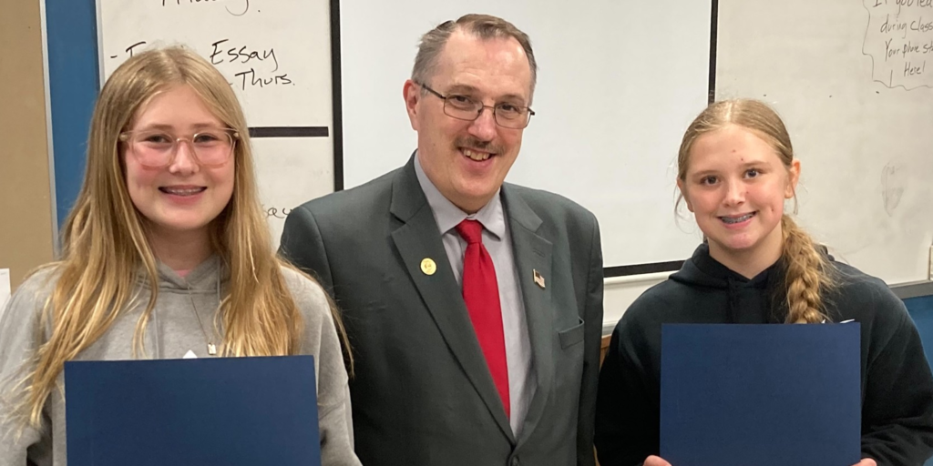 Two student winners with award giver