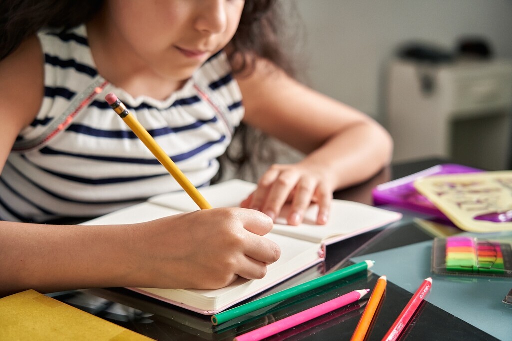Student writing in notebook