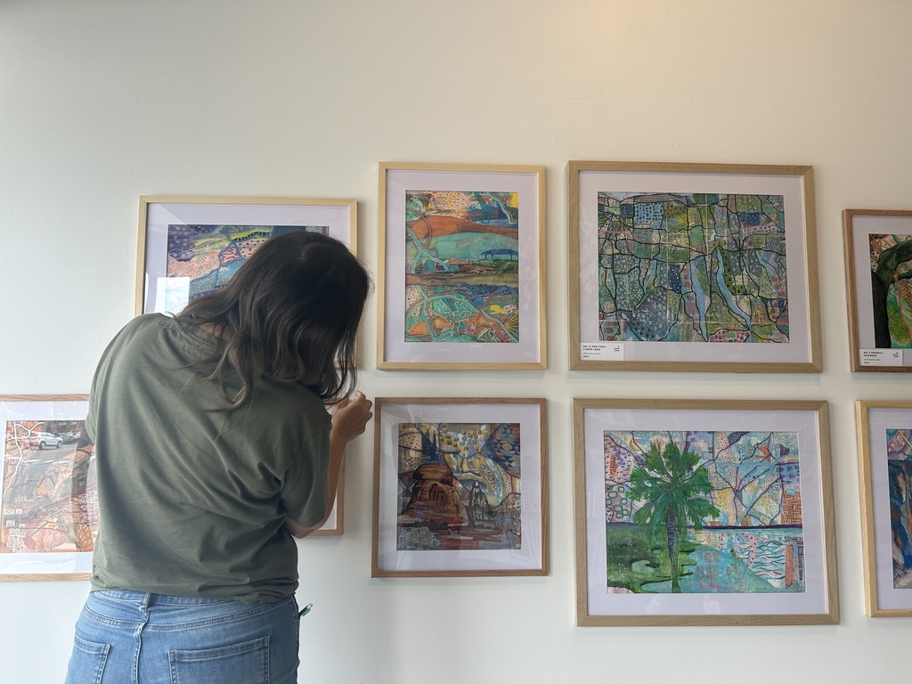 Mrs. Hartke stands in front of her artwork at The Gallery in the Valley