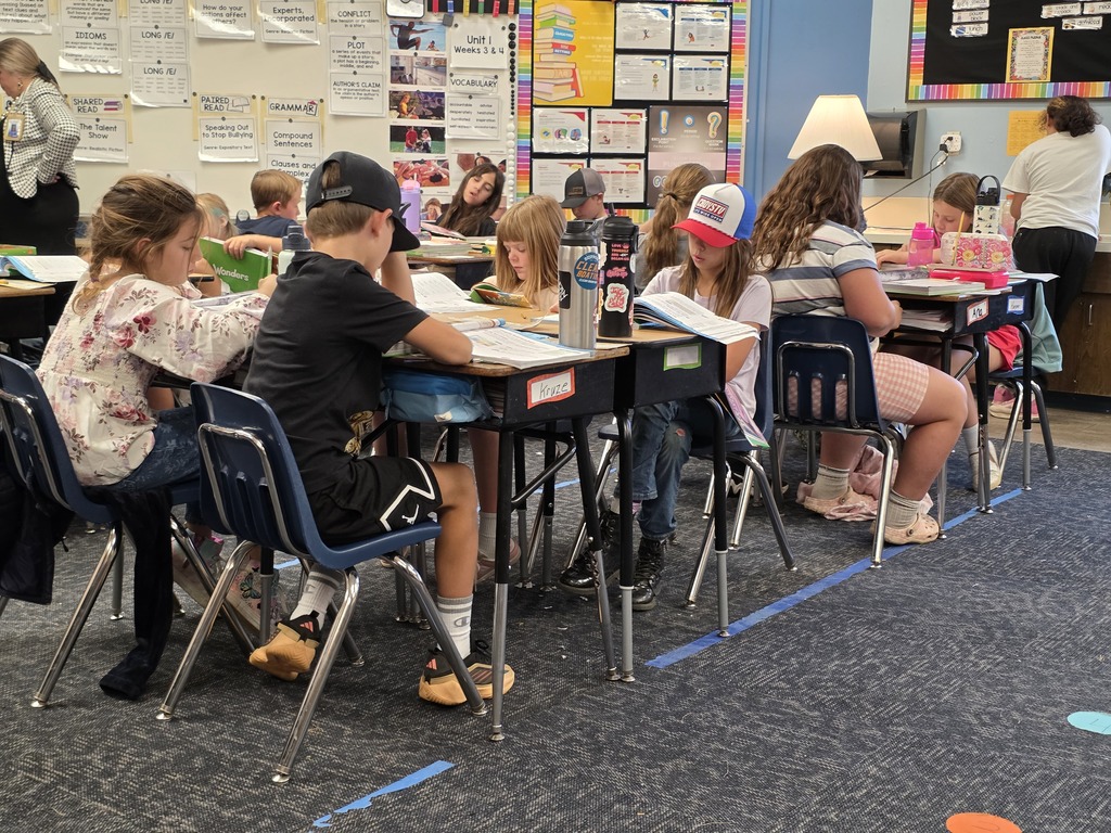 Students reading about business and it's impact on our community.