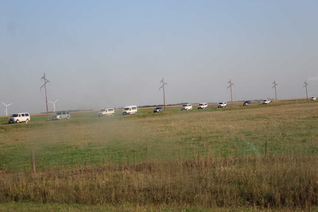 Line of vans and buses headed to the Range Judging Site