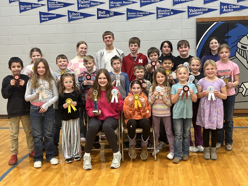 group of children holding spelling bee ribbons