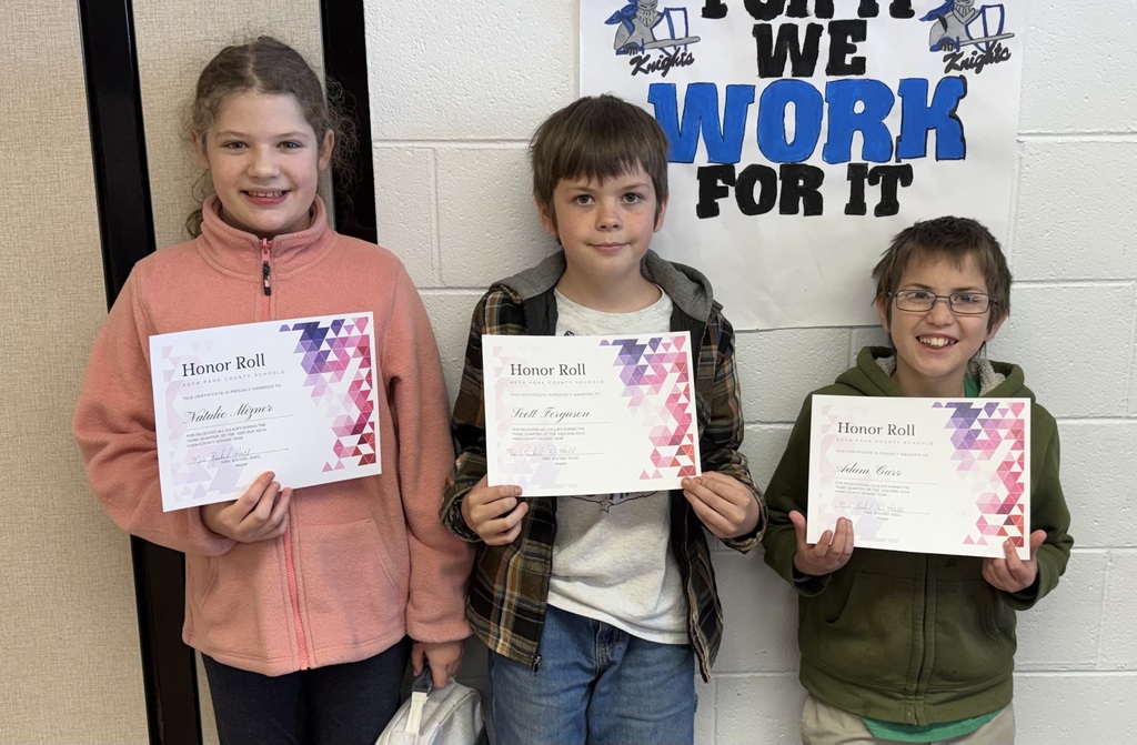 3 students holding honor roll certificates