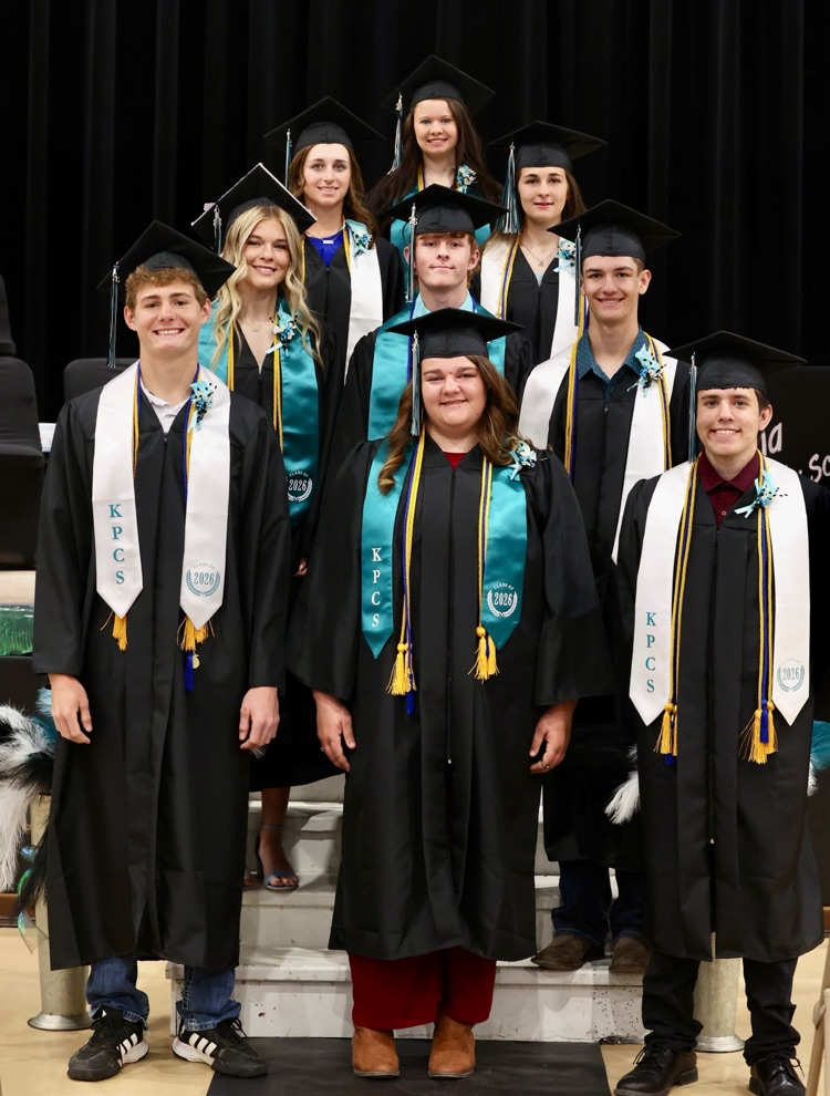 group of nine students in graduation attire