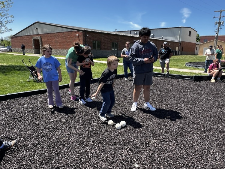 giving guidance to kids throwing softball