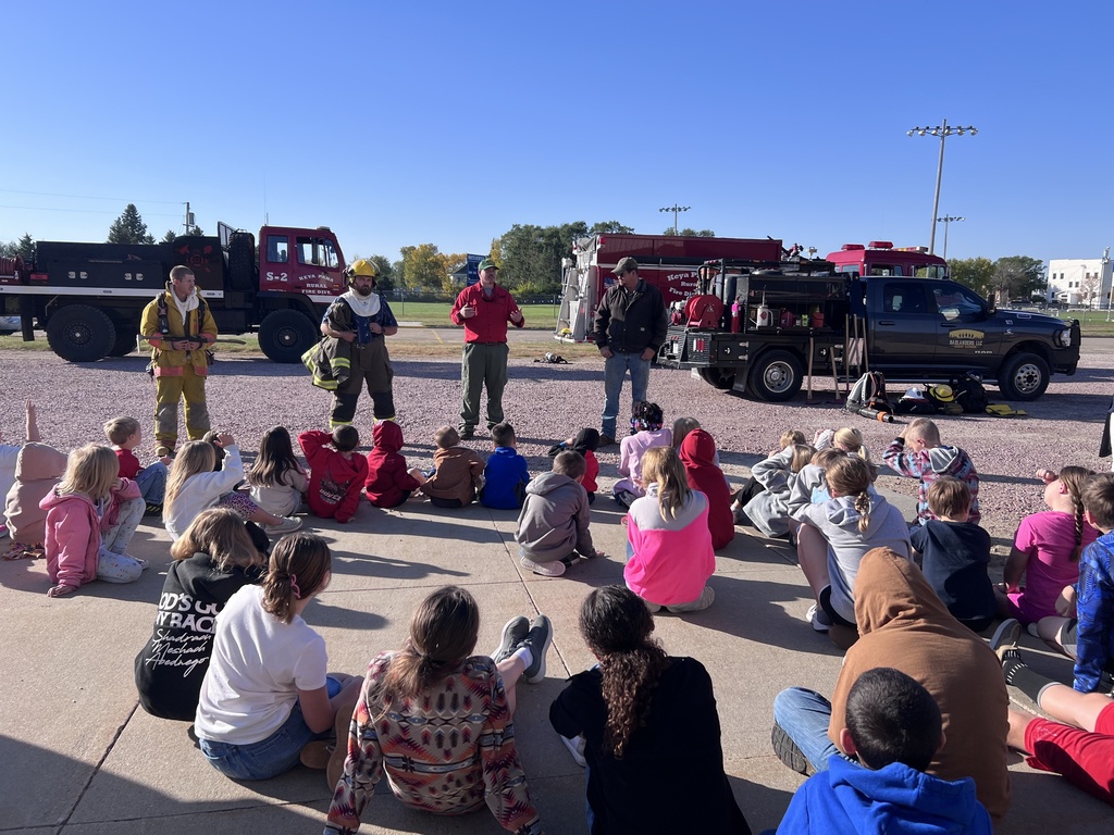 firemen talking to group of kids