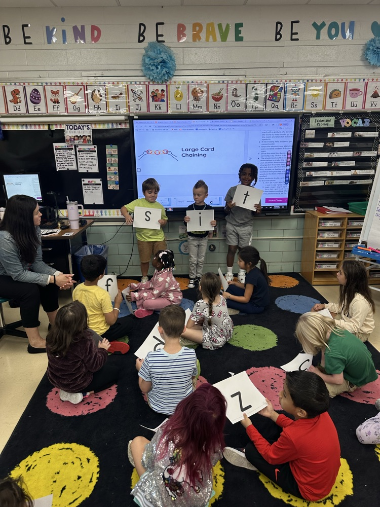 Students are making short vowel words with large letter cards during skills!