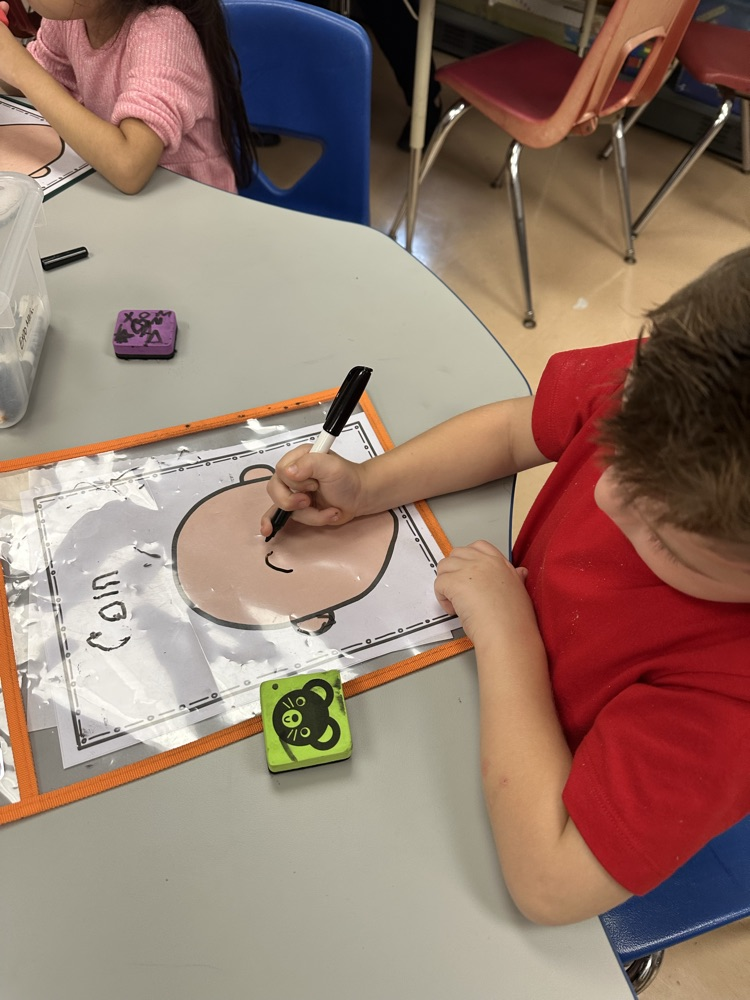 Cain is using his strokes to write his name.