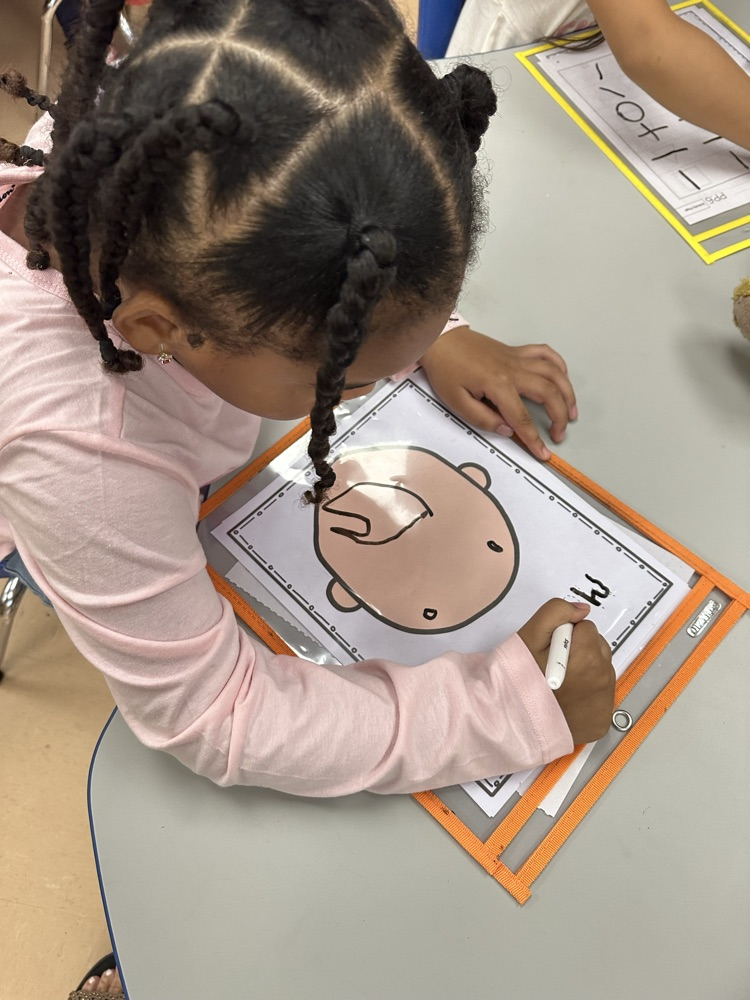 Maite is using the strokes she learned to write her name.