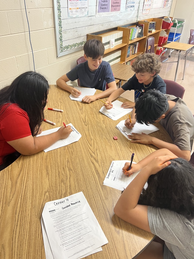 Students working in a small group on a center.