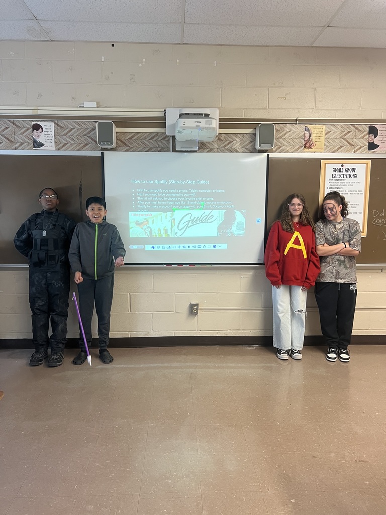Students presenting their multimedia presentation with a guest appearance from a student who was borrowing a charger and wanted to get in the picture! 