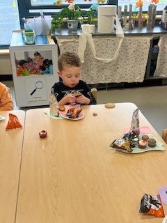 Student sitting and eating at Halloween Party