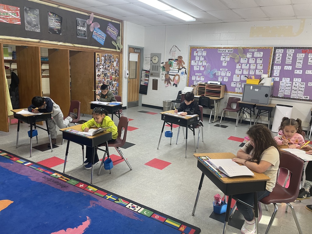 The students are hard at work writing complete sentences in their journals!