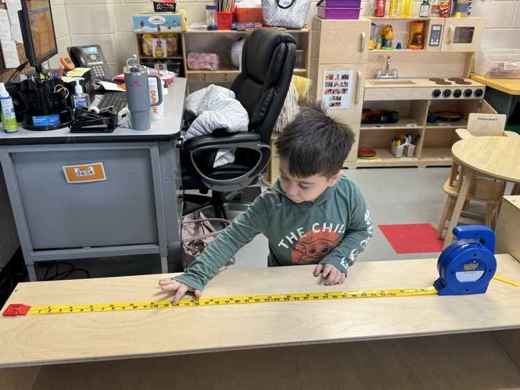 child counting using a tape measure 