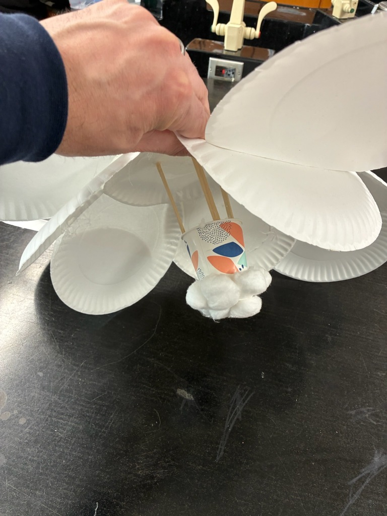 8th Grade Science students designed and created a parachute to safely land an egg when dropped from the second floor to the first floor for the physical science unit.