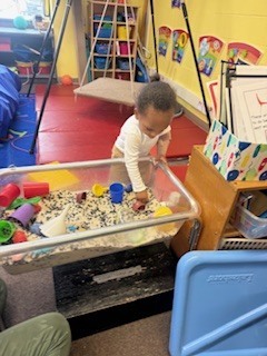 Child playing in rice box.