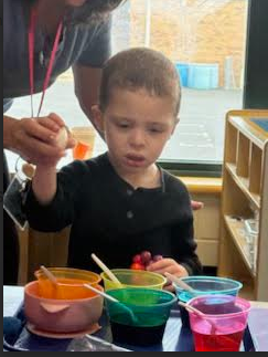 Child dyeing eggs.