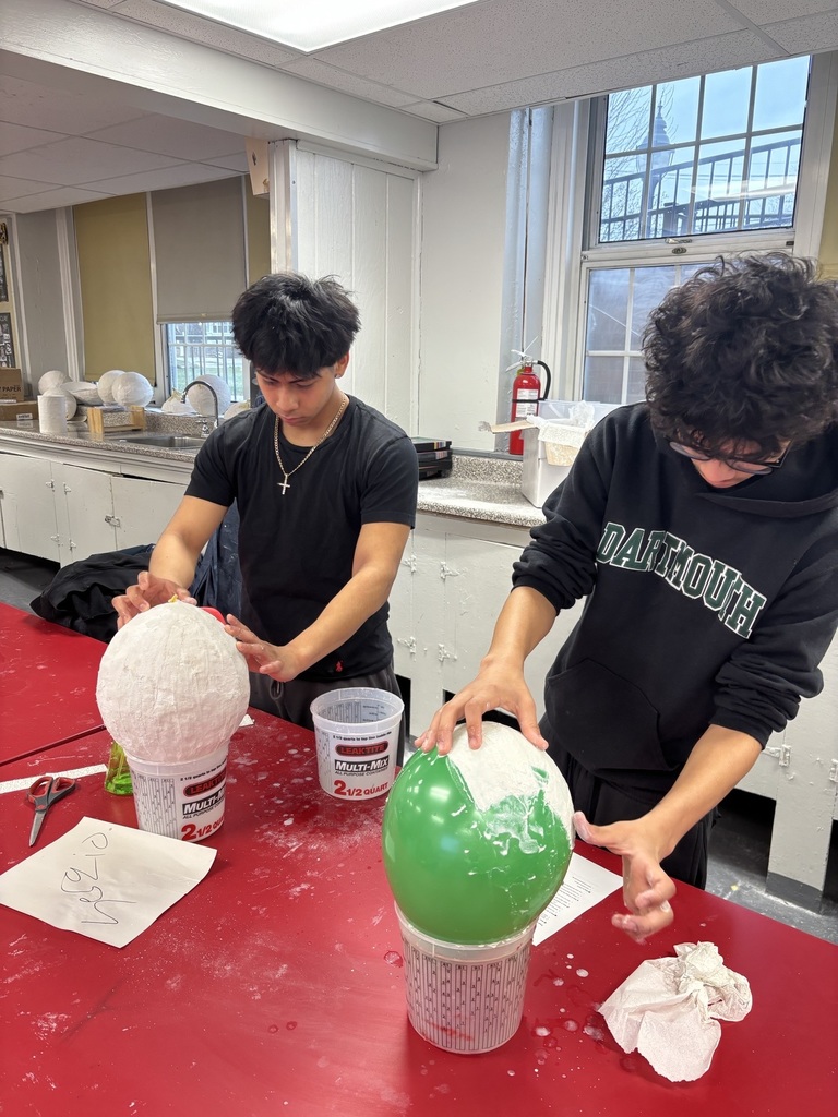 Art 1 students working hard using plaster to create the base of their masks!