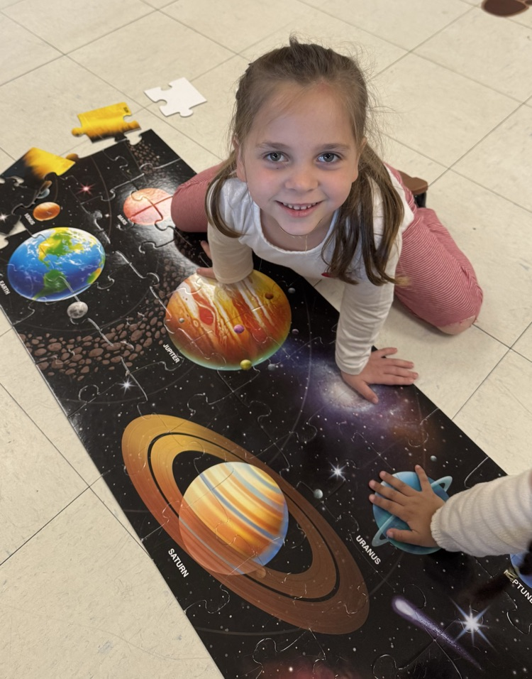 girl finishing a puzzle