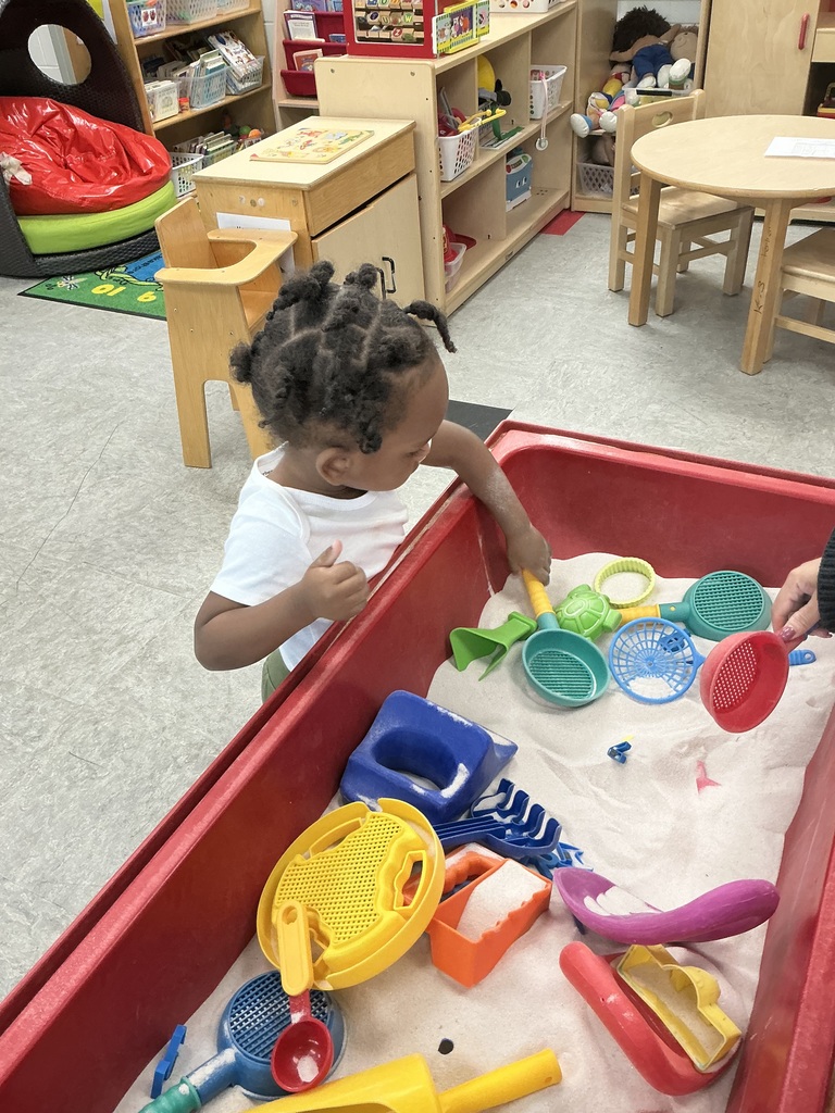 Pre K student playing in sandbox.