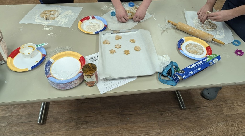 students rolling cutting and baking dog treats 