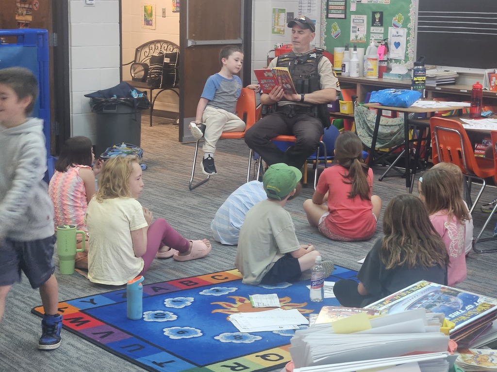 DCSO Carney reading to the Summer School Kids