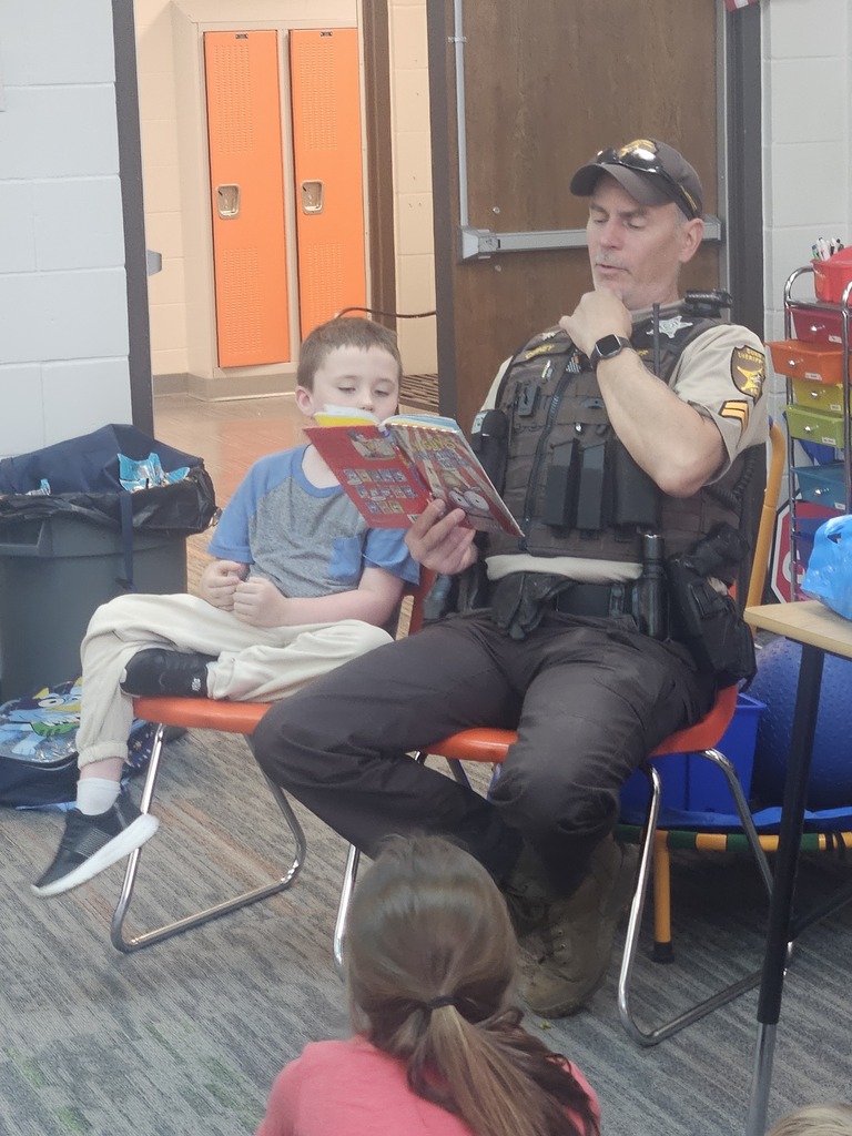 DCSO Carney reading to the Summer School Kids