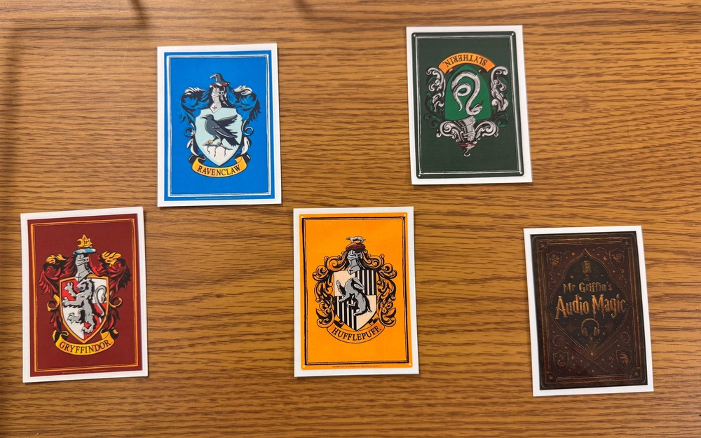cards on a table with Hogwarts house names