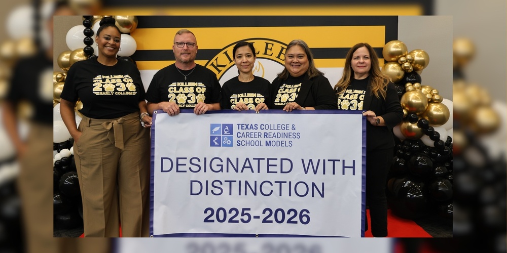 group of adults holding up a banner smiling that reads designated with distinction 2025-2026