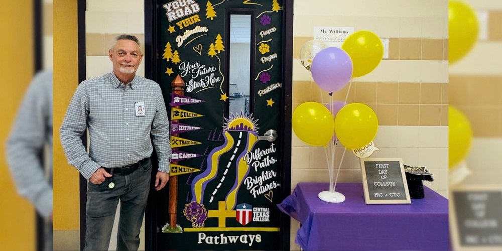 man standing in front of door smiling at the camera
