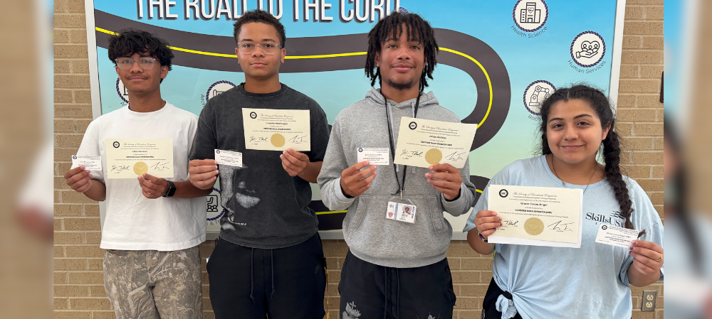 group of students holding their certificates of completion smiling