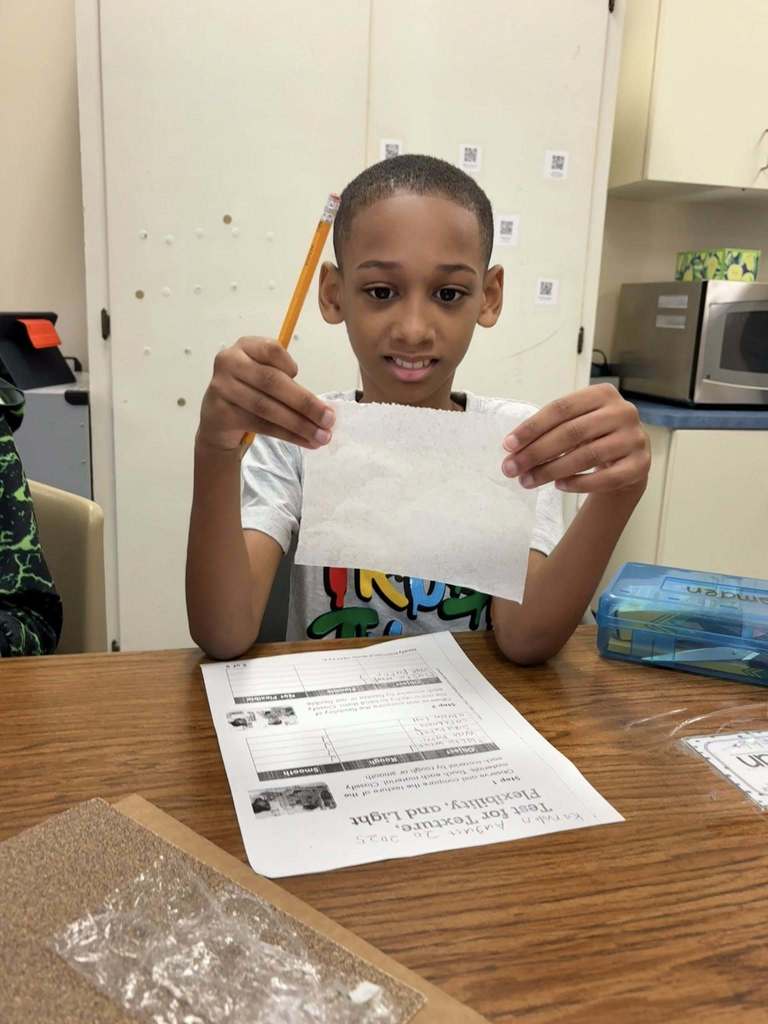student touching wax paper