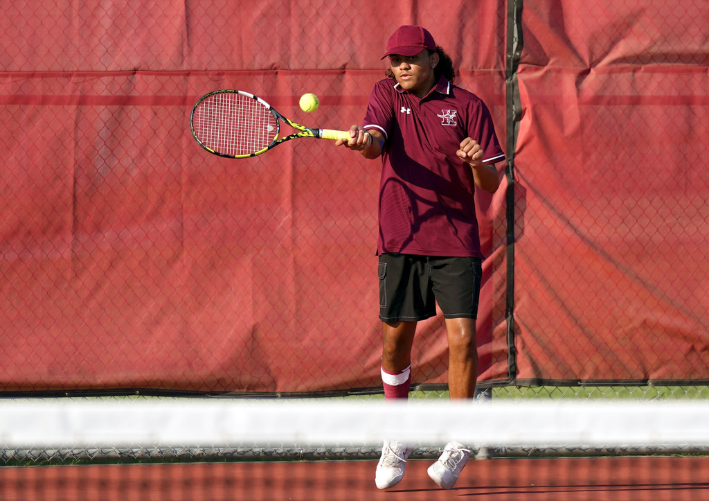 KHS tennis player hits the ball
