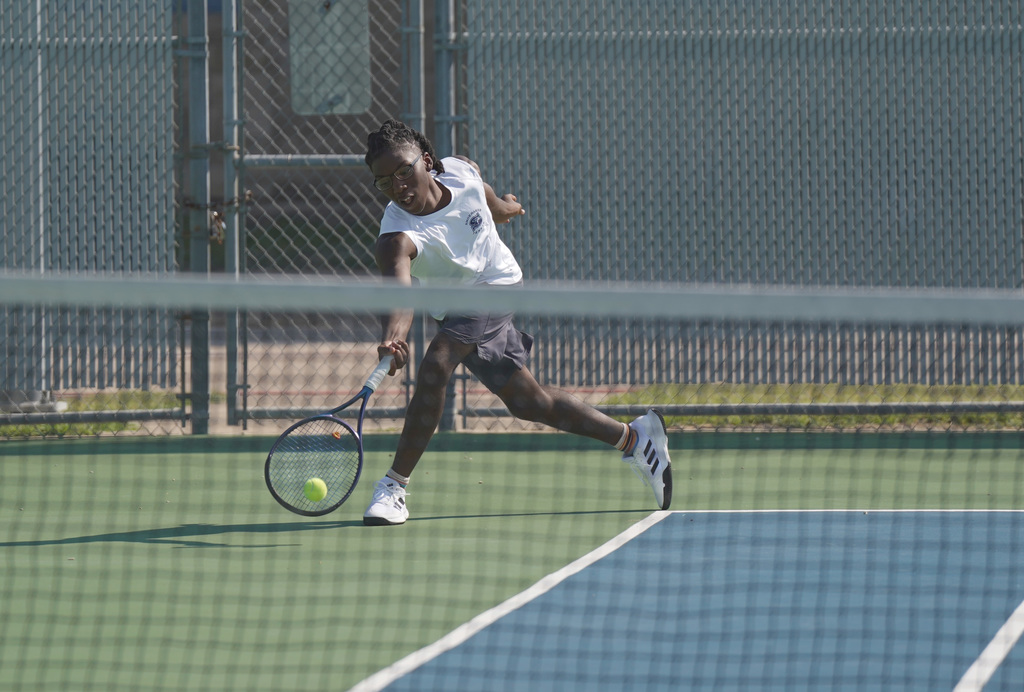 Shoemaker tennis player hits the ball
