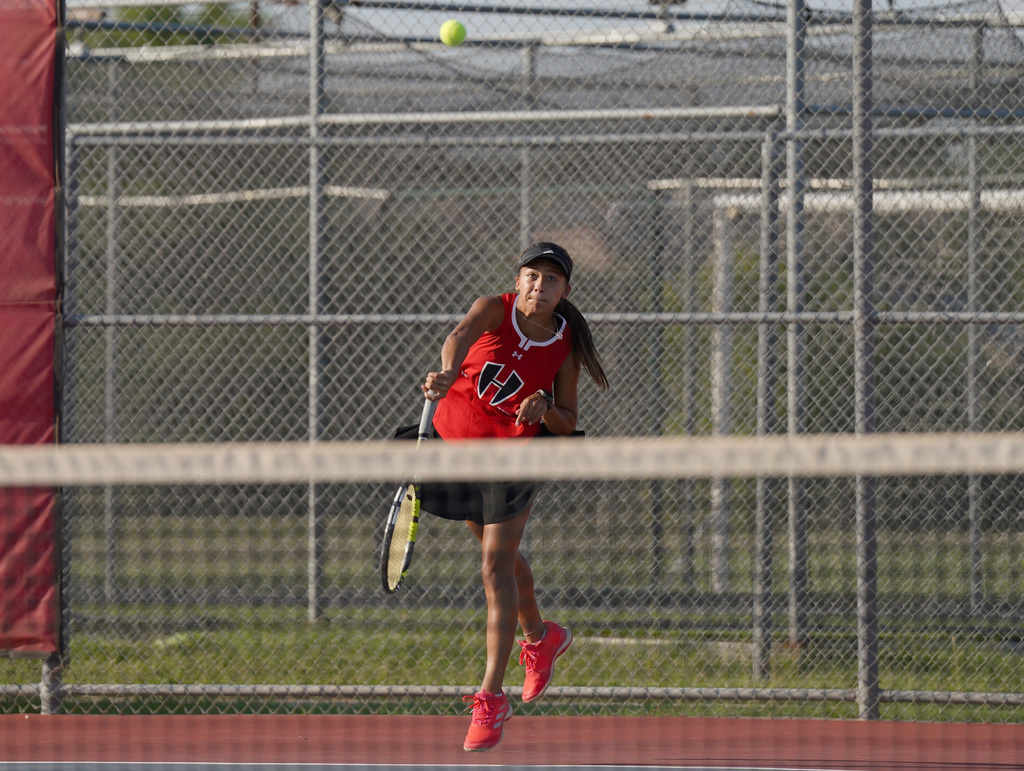 HHHS tennis player serves