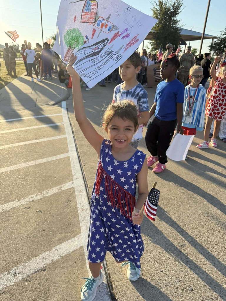 student displaying sign