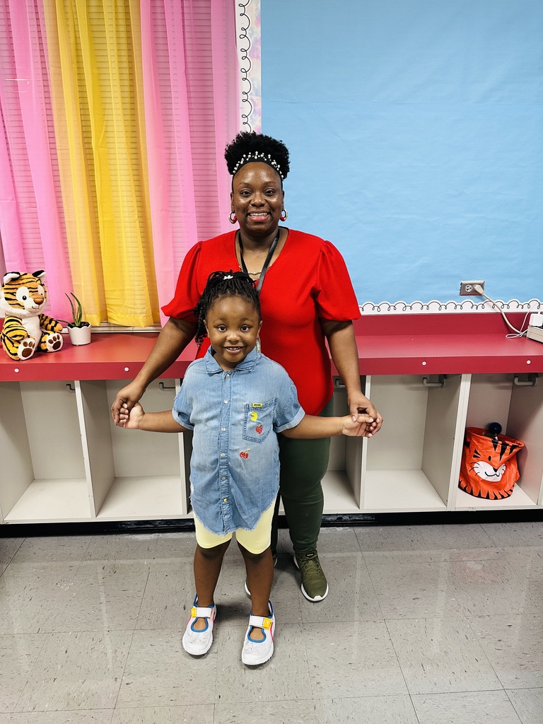A woman and a girl posing for a picture