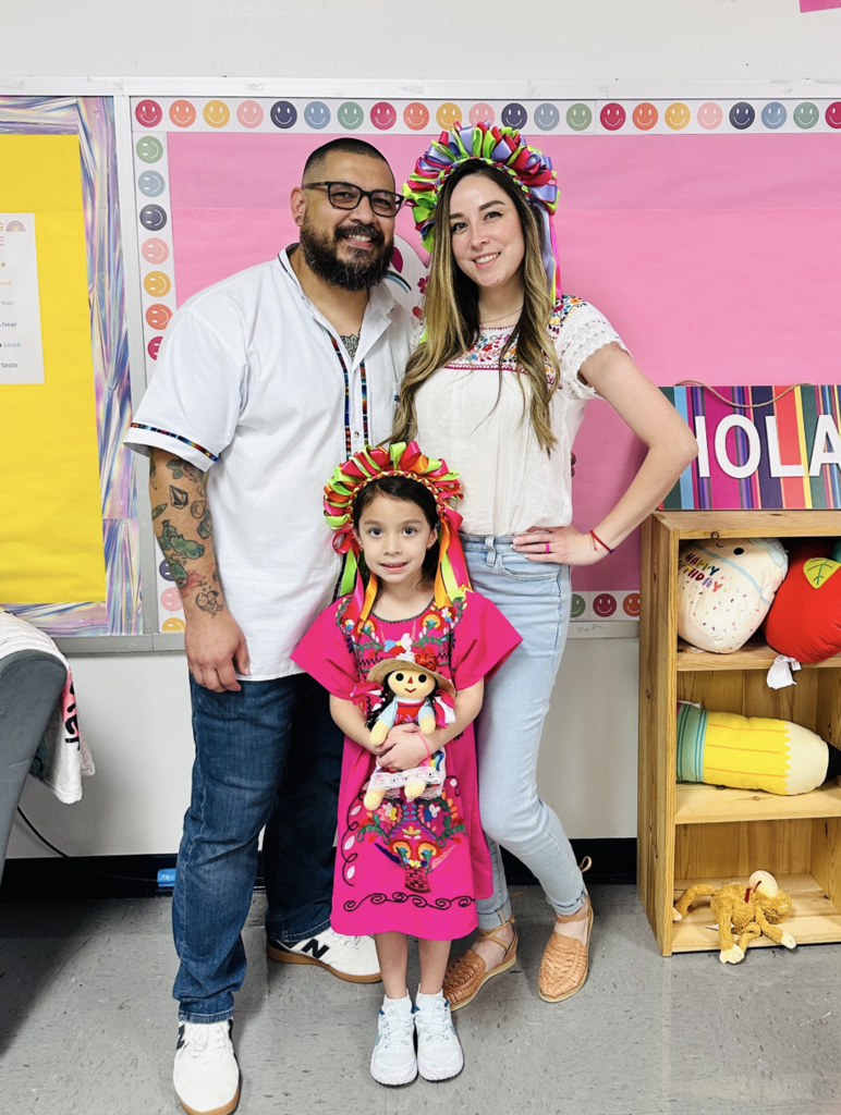 A man, woman, and child posing for a picture