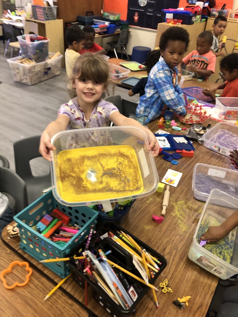 students playing with sand and objects